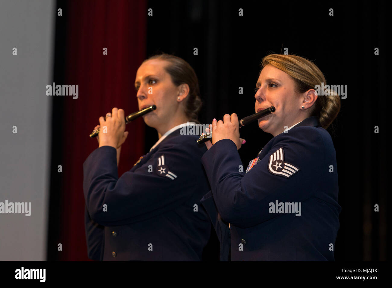 Flutists Airmen 1st Class Elizabeth Robinson (left) and Staff Sgt. Carolyn Sierichs (right), from Band of the West perform as part of Fiesta in Blue in San Antonio, Texas April 24, 2018. The act was dedicated to the 300th Anniversary of San Antonio and honors the city's military heritage. Since 1891, Fiesta has grown into an annual celebration that includes civic and military observances, exhibits, sports, music and food representing the spirit, diversity and vitality of San Antonio. (U.S. Air Force photo by Ismael Ortega / Released) Stock Photo