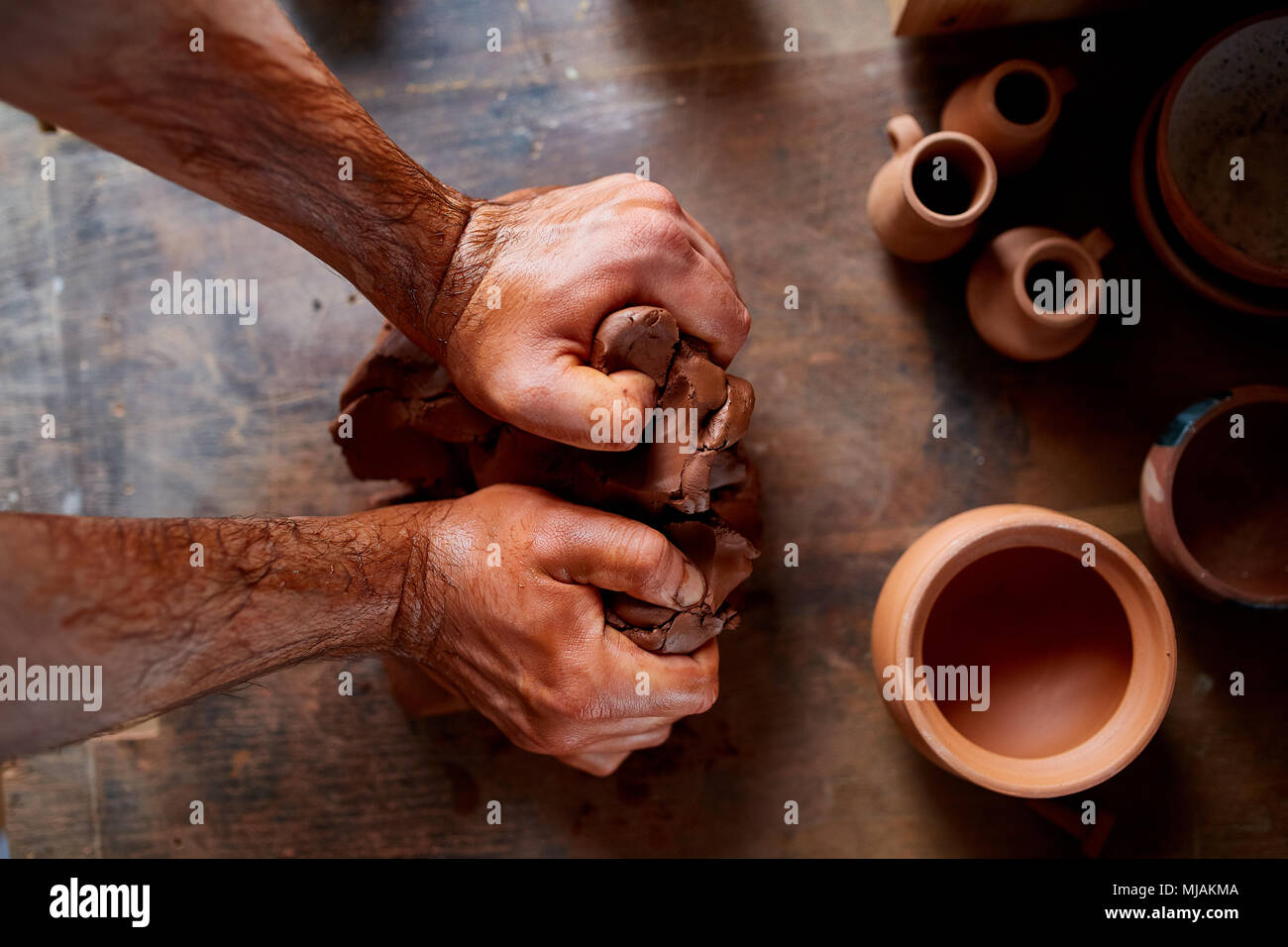 Artisan potter prepares material clay for pottery. Man knead clay before  molding. Male sculptor is pugging and kneading clay for creating ceramics  in Stock Photo - Alamy