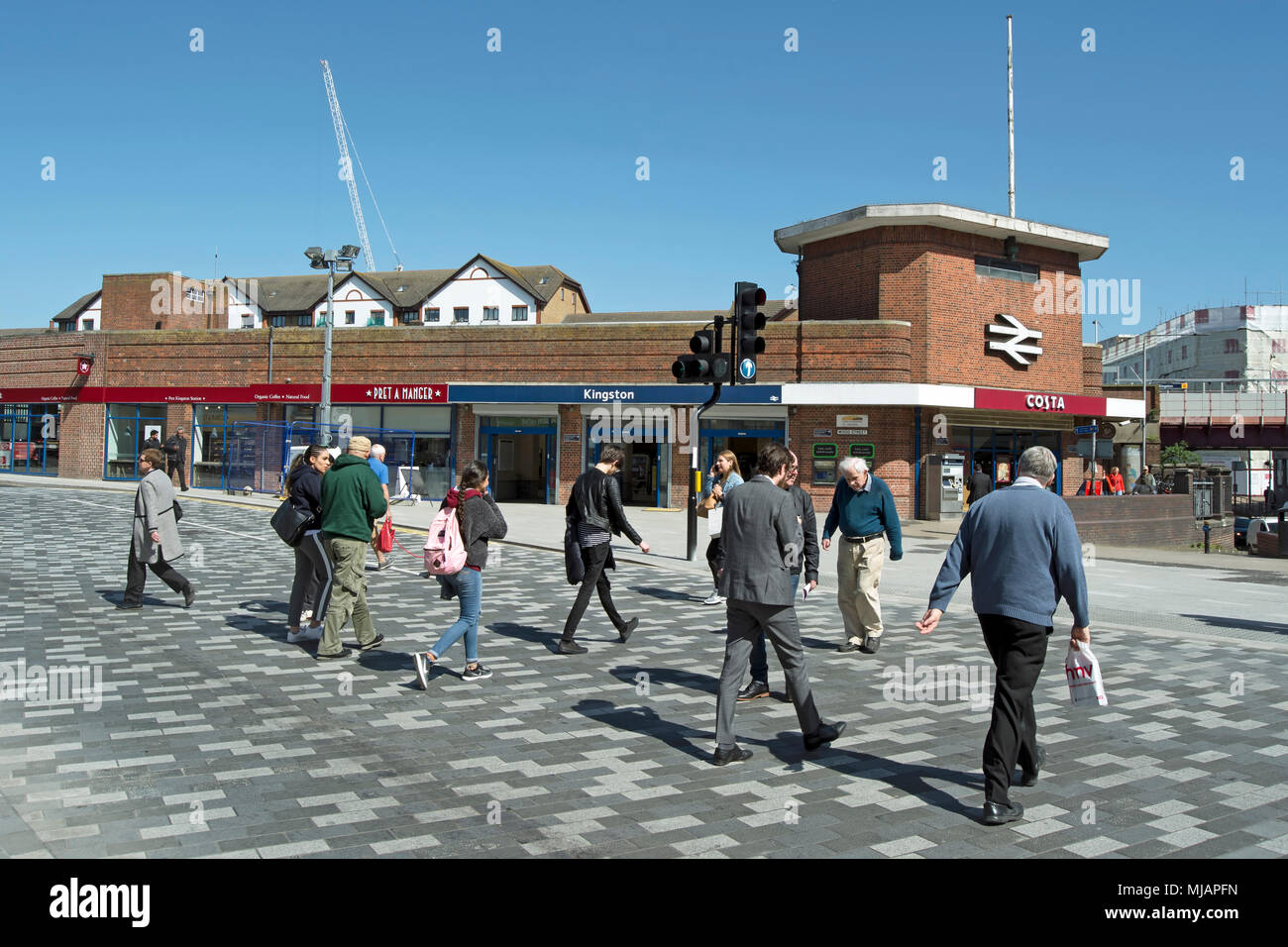 pedestrians cross the road near kingston railway station, kingston upon