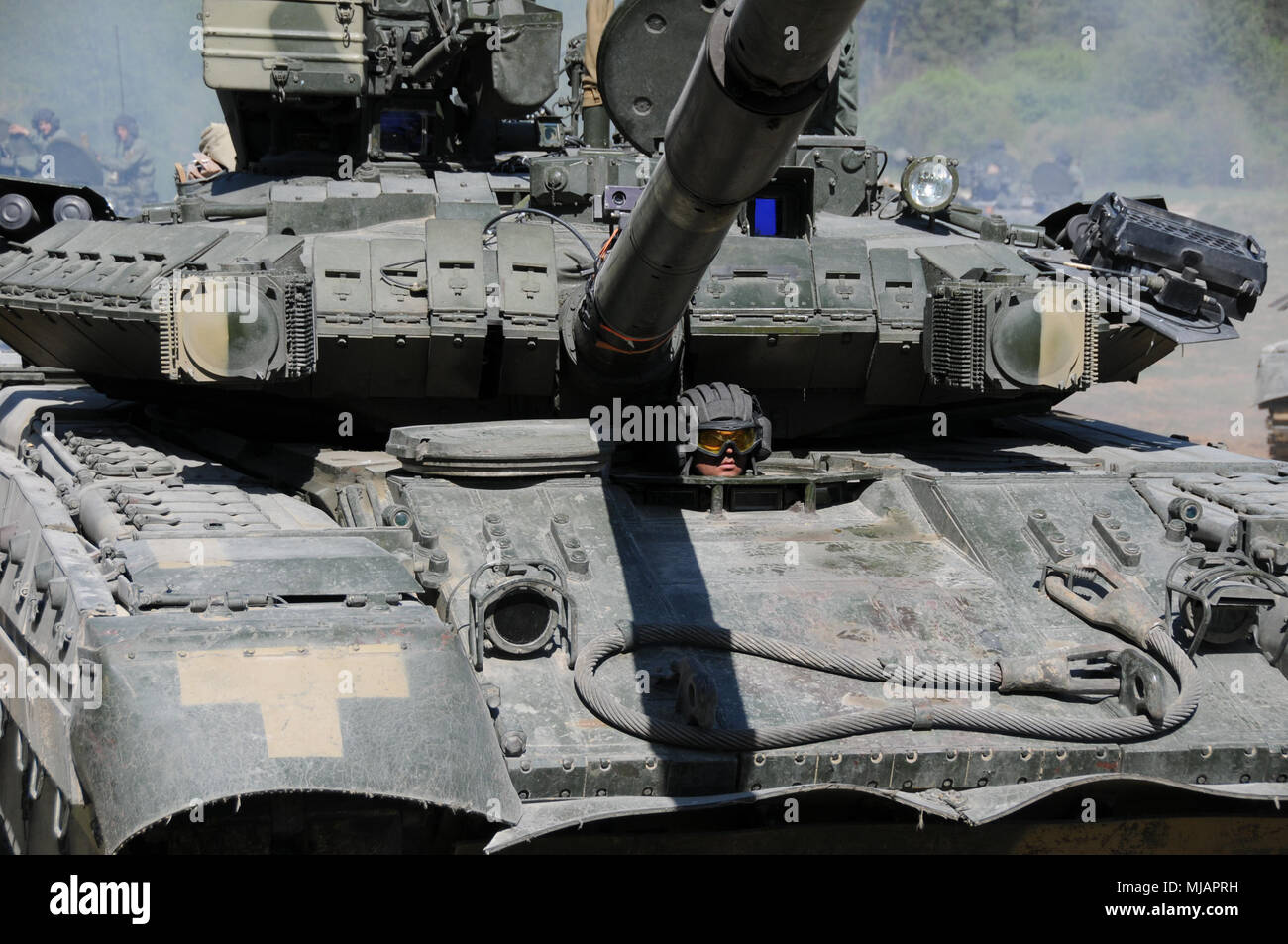 A Ukrainian Army soldier drives a T-84 tank into position in the Hohenfels Training Area, Hohenfels, Germany, during Combined Resolve X, April 27, 2018. Combined Resolve X includes approximately 3,700 participants from 13 nations at the 7th Army Training Command’s Grafenwoehr and Hohenfels Training Area, April 9 to May 12, 2018. Combined Resolve is a U.S. Army Europe-directed multinational exercise designed to give the Army’s regionally allocated combat brigades to Europe a combat training center rotation with a joint, multinational environment. (U.S. Army photo by Sgt. Brian Schroeder/145th M Stock Photo