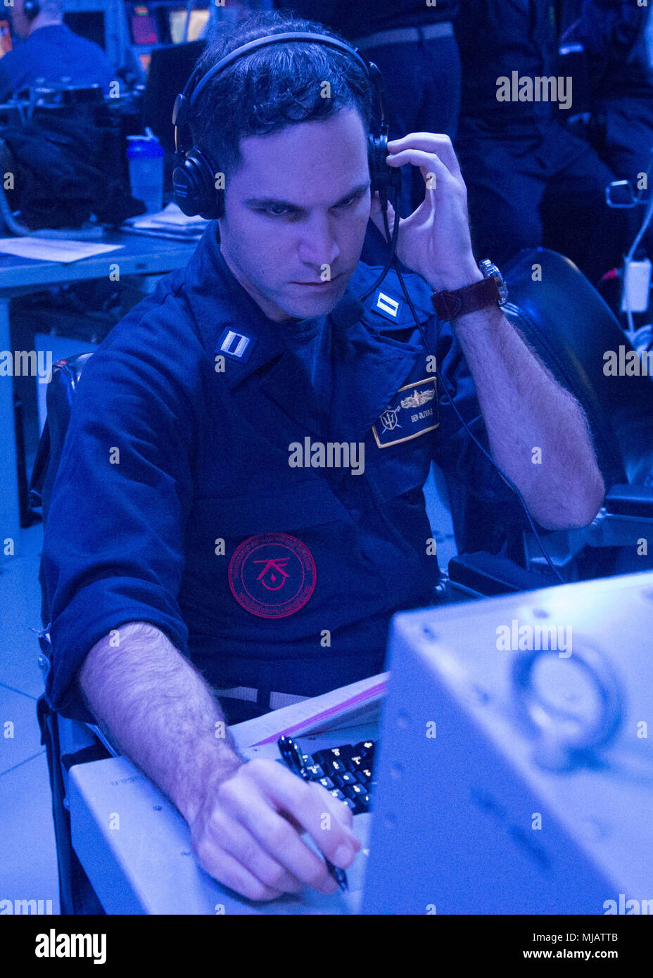 Pacific Ocean (April 23, 2018) Lieutenant Ben Olivas,  a Warfare Tactics Instructor (WTI) assigned to Naval Surface and Mine Warfighting Development Center (SMWDC) monitors a fast attack craft fast inshore attack craft (FAC/FIAC) event during an underway Cruiser-Destroyer (CRUDES) Surface Warfare Advanced Tactical Training (SWATT) exercise aboard USS Stockdale (DDG 106).  Stockdale is one of three warships from USS John C. Stennis (CVN 74) Carrier Strike Group (CSG) completing a CRUDES SWATT exercise.  USS Mobile Bay (CG 53) and USS Spruance (DDG 111) are also participating in the SMWDC-led ex Stock Photo
