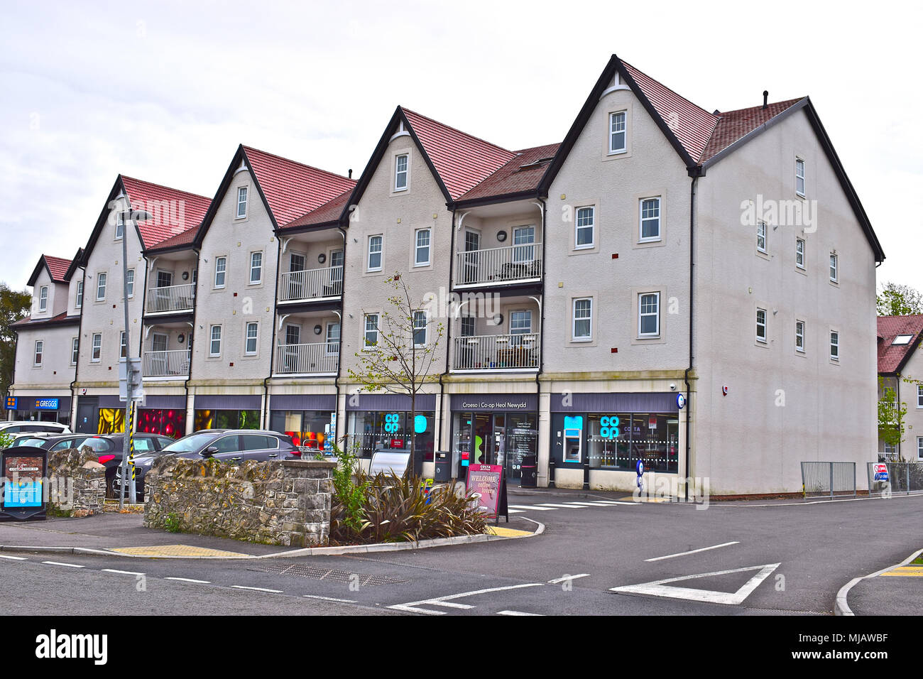 A newly completed block of modern flats with retail premises on ground
