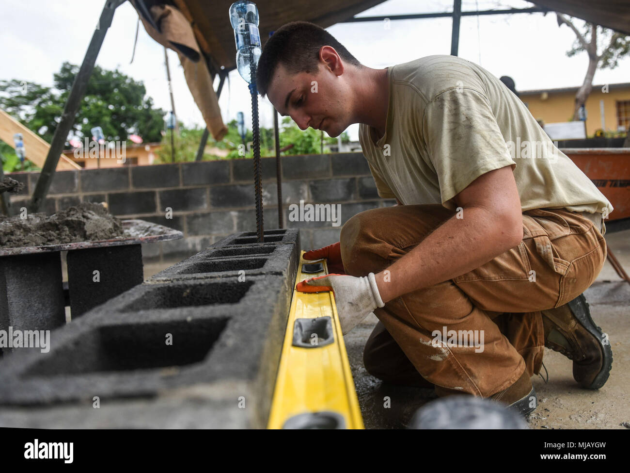 U.S Air Force Senior Airman Andrew Nameth, 346th Air Expeditionary Group Rapid Engineer Deployable Heavy Operational Repair Squadron Engineer member who is deployed from Nellis Air Force Base, Nev., ensures a wall is level April 27, 2018 at a construction site in Meteti, Panama. Nameth is participating in Exercise New Horizons 2018, which will assist communities throughout Panama by providing medical assistance and building facilities such as schools, a youth community center and a women’s health ward. (U.S. Air Force photo by Senior Airman Dustin Mullen/Released) Stock Photo
