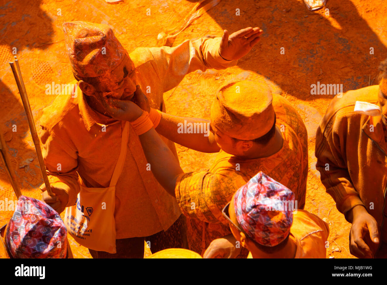 Applying vermilion color during Thimi color festival (Sindoor Jatra), Nepali new year, april 2018 Stock Photo