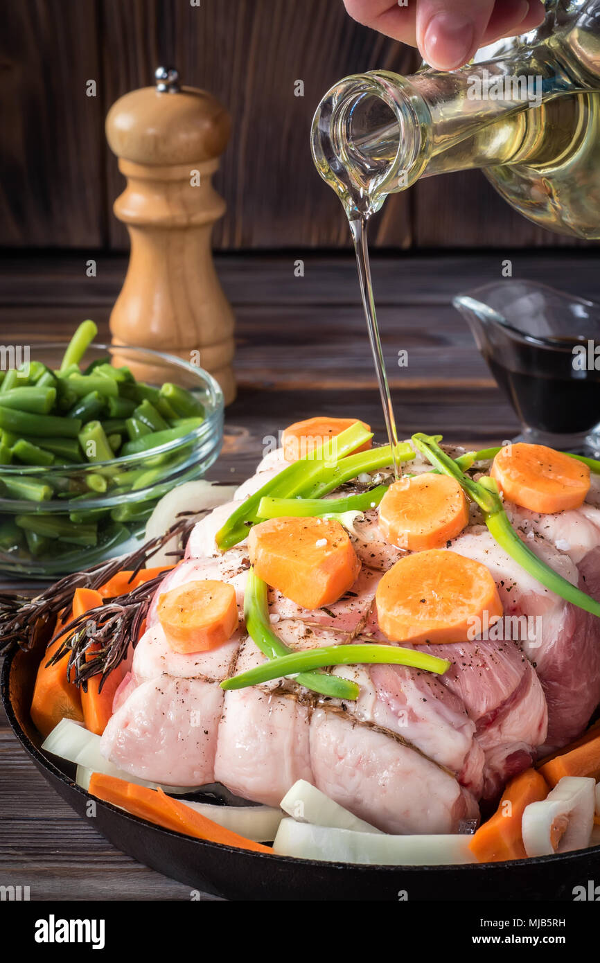 Raw pork chop meat roll wrapped with twine jute marinated pour olive