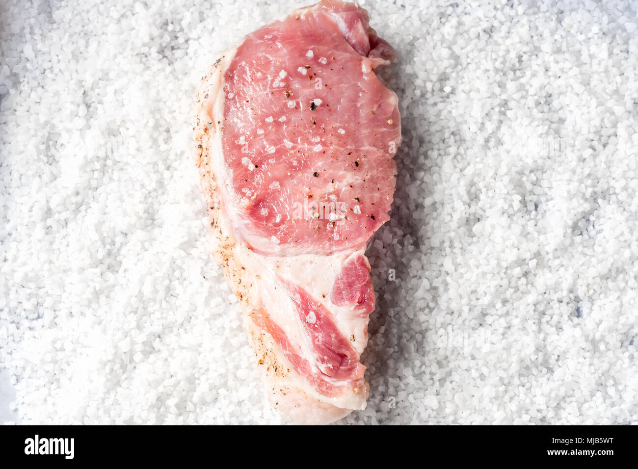 Slice Steaks Raw Pork Chop marinated meat on background of coarse sea