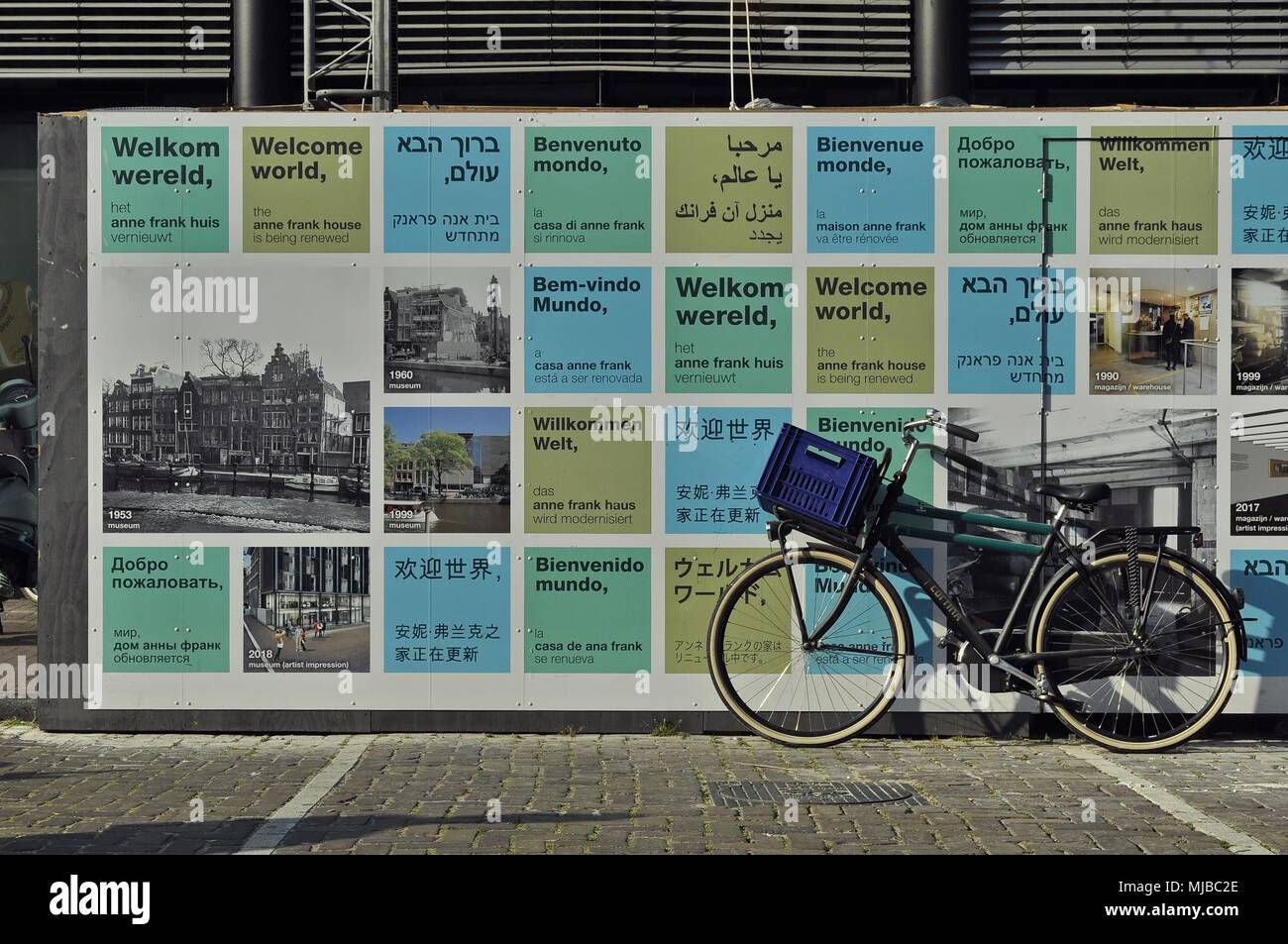 Amsterdam, Netherlands: Landscape view of a wall with welcome signs in different world languages at the Anne Frank Museum on the Prinsengracht. Stock Photo
