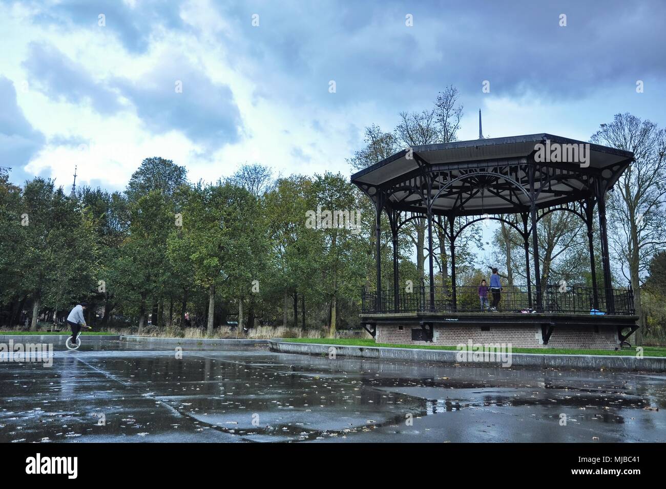 Amsterdam, Netherlands: The outdoor pavilion in the Oosterpark with locals young man practicing the mono-cycle the band stand Stock Photo - Alamy