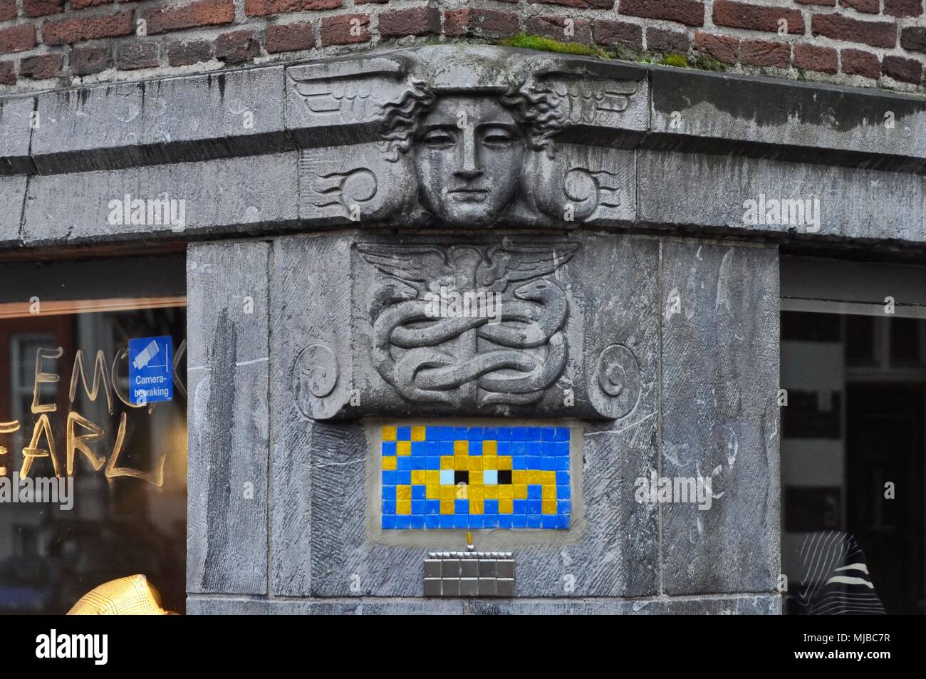 Amsterdam, Netherlands - January 4, 2018: Space Invader mosaic tile street art on the corner of the Keizersgracht and Berenstraat Stock Photo