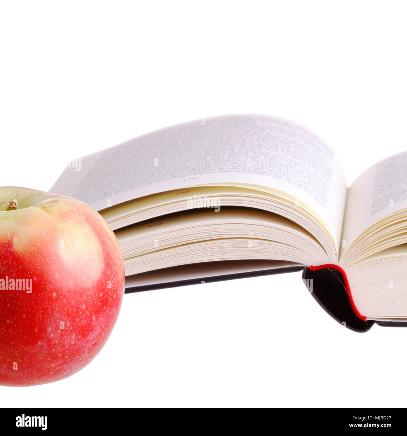 The apple of wisdom at the side of a book. Stock Photo