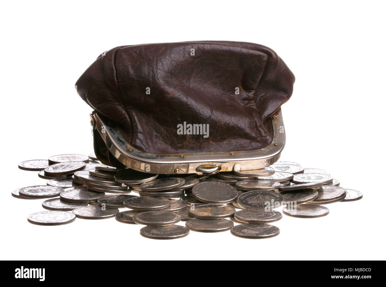 A brown purse upside down on top of a pile of Swedishcoins, isolated on white background. Stock Photo