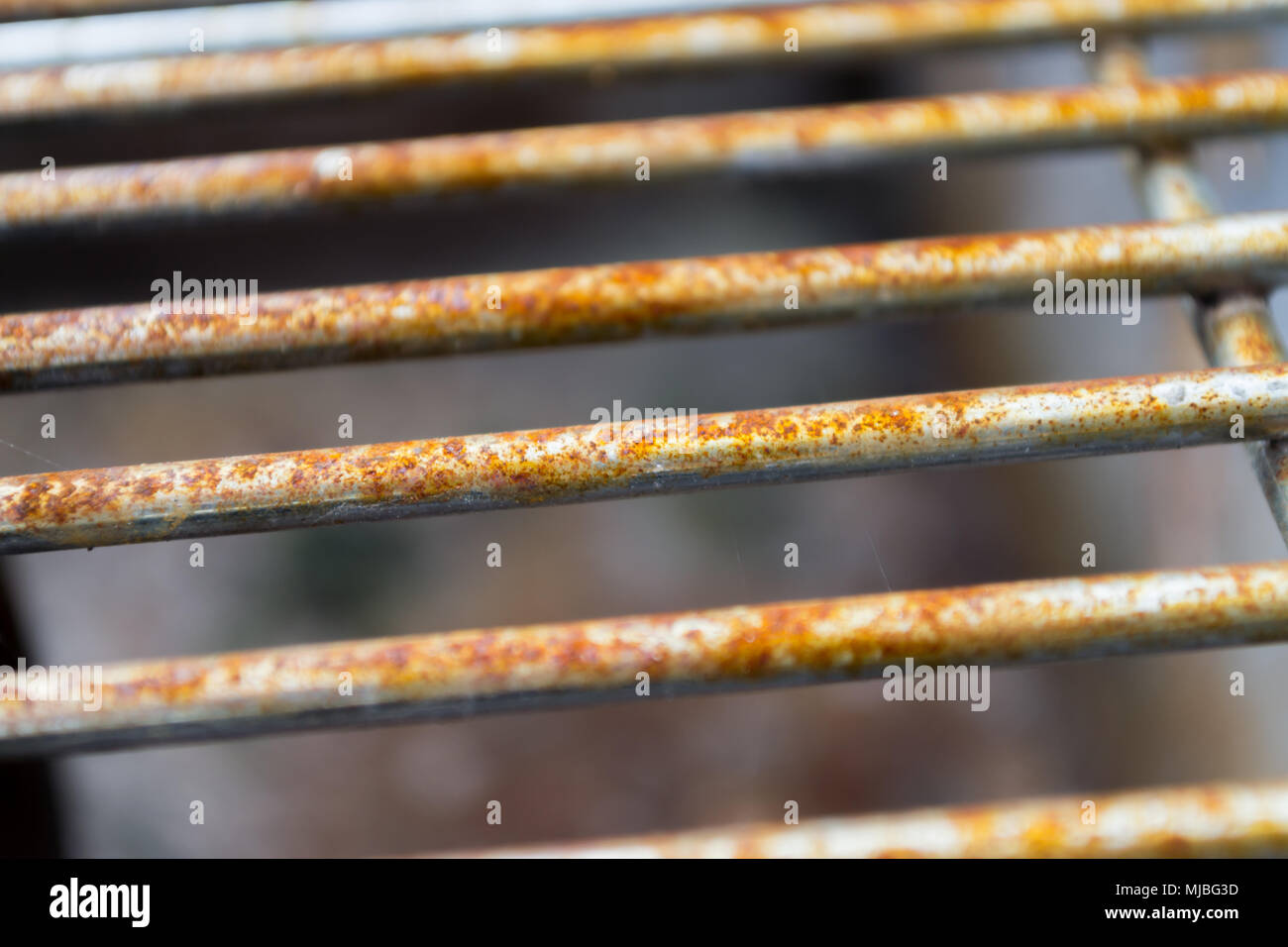 Rusted metal grill bars pictured horizontally showing signs of deterioration Stock Photo