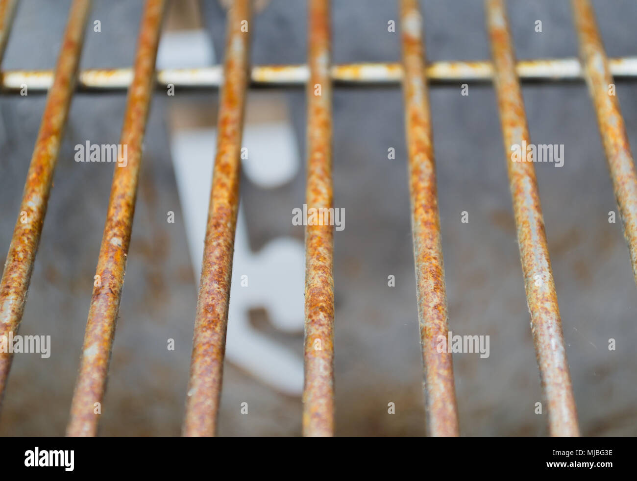Rusted metal grill bars pictured vertically showing signs of