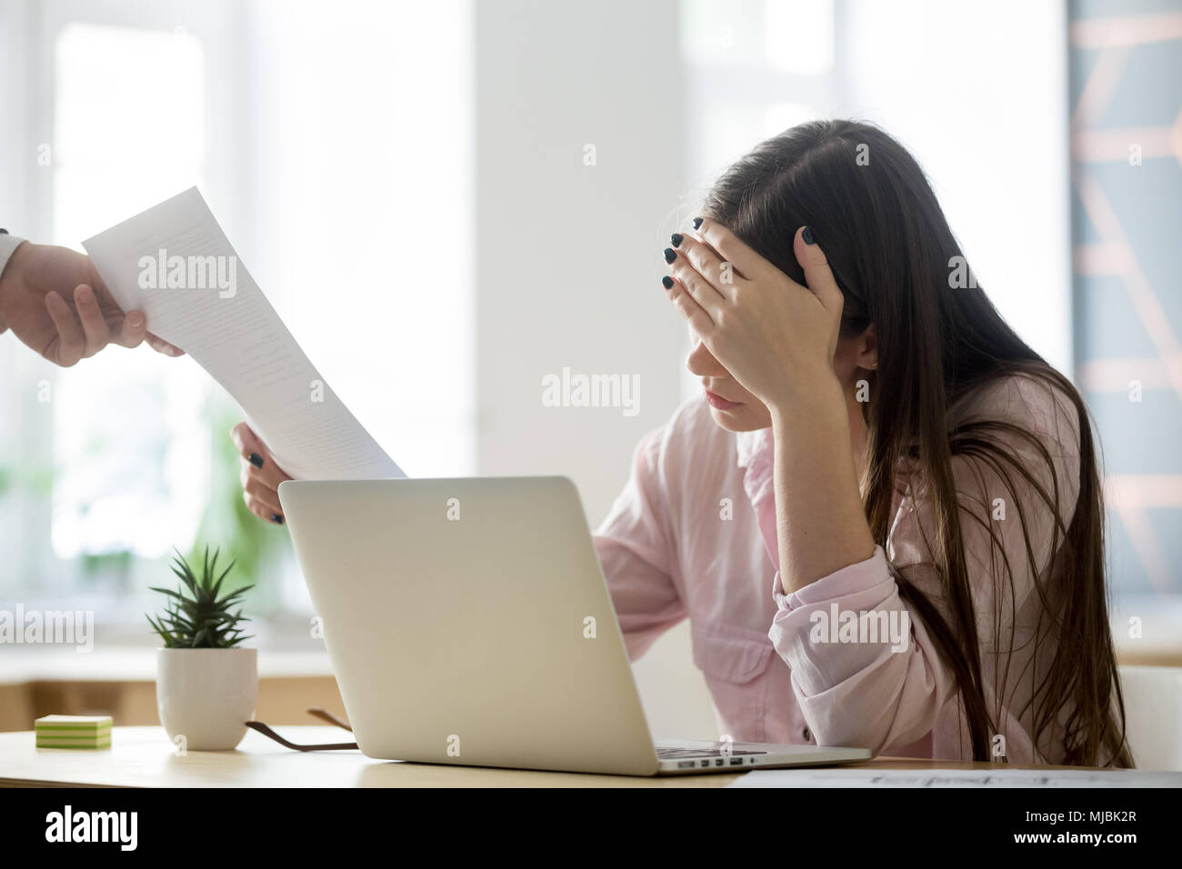 Frustrated female employee feeling upset receiving dismissal not Stock Photo