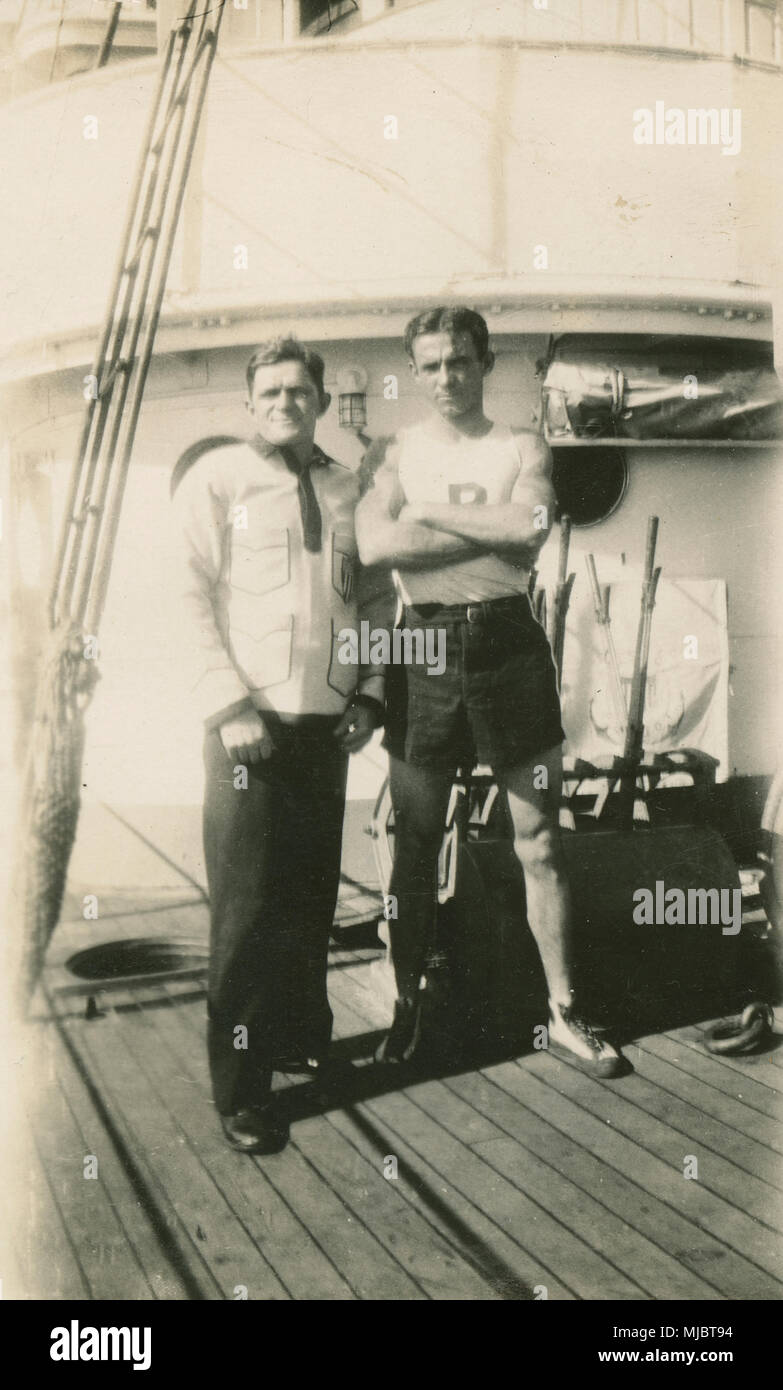 Antique c1922 photograph, view aboard the cable ship USCG Pequot. Two sailors in sports gear. SOURCE: ORIGINAL PHOTOGRAPHIC PRINT. Stock Photo