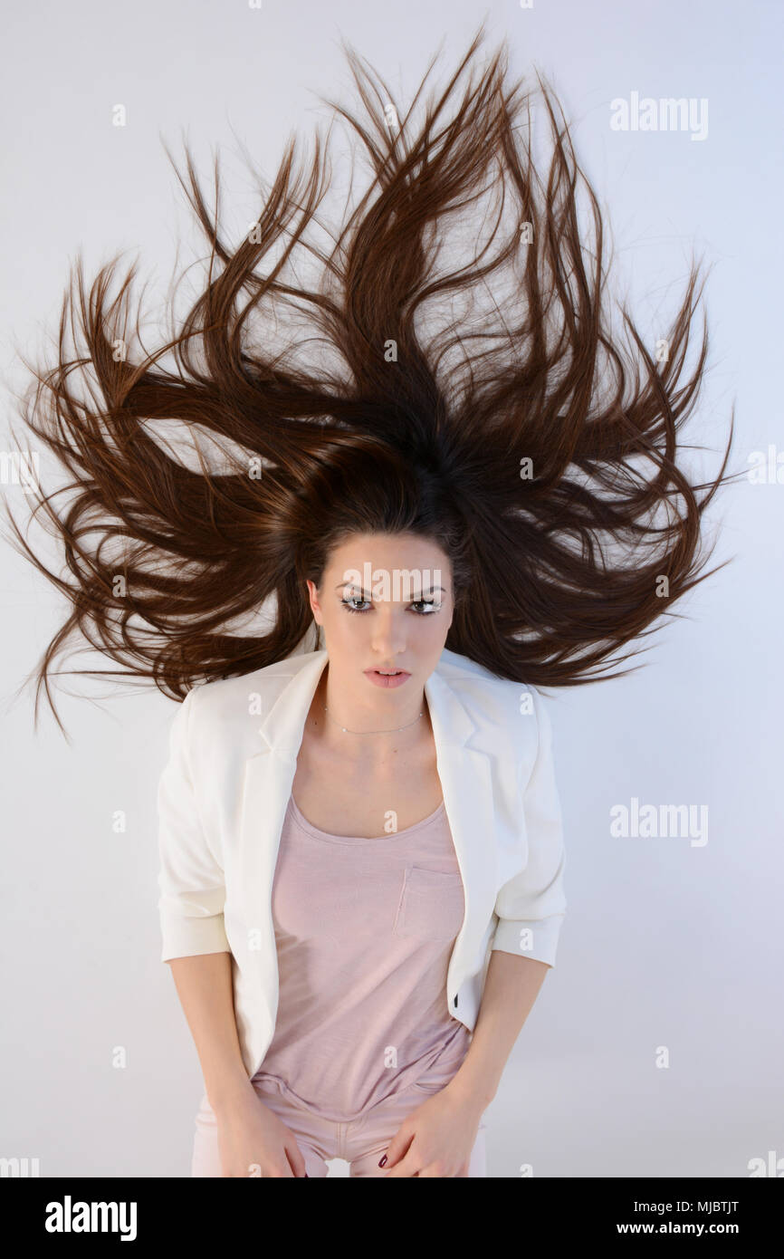 Beautiful long hair woman lie on floor Stock Photo - Alamy