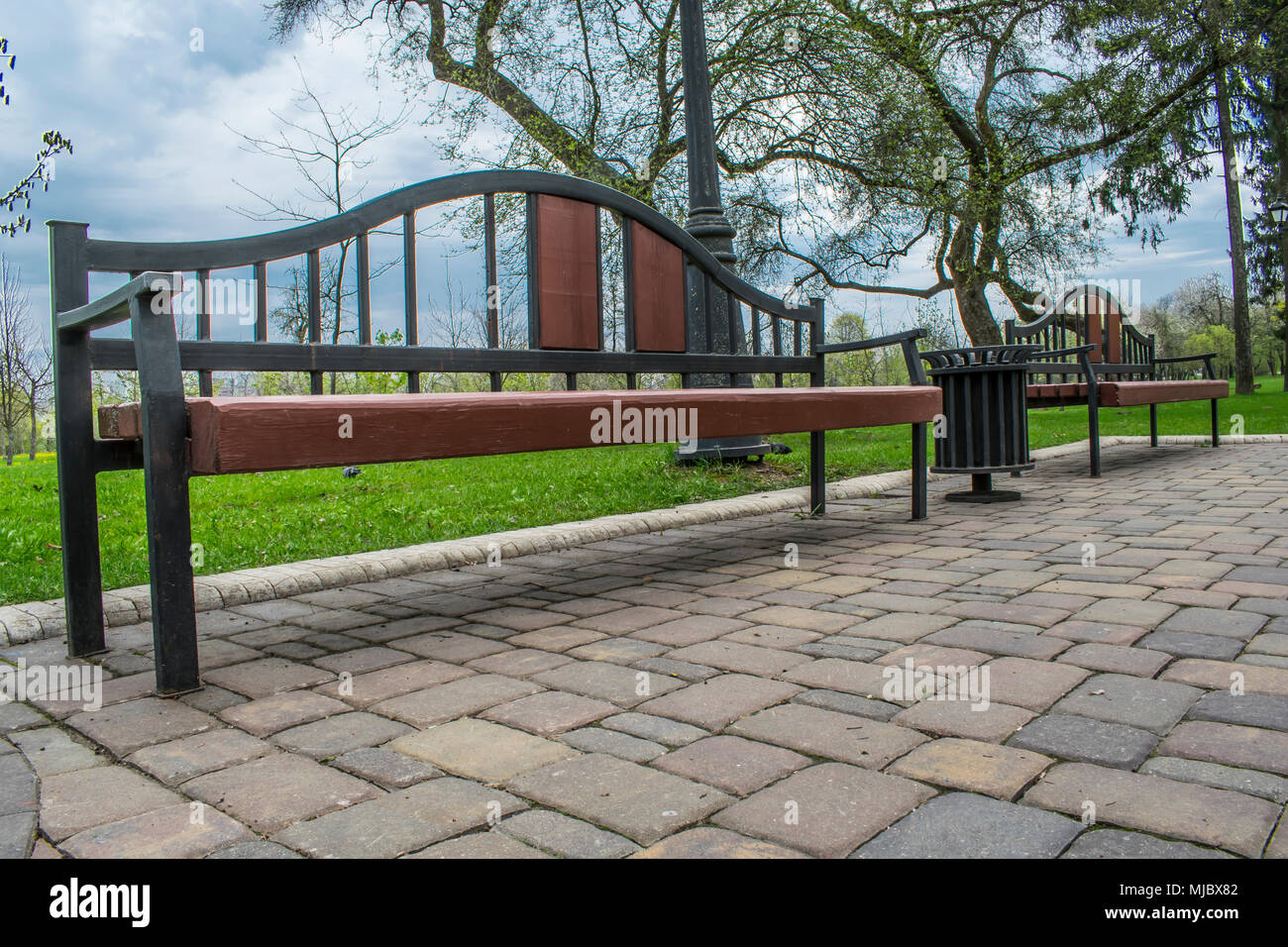 Wooden bench in the city park Stock Photo - Alamy