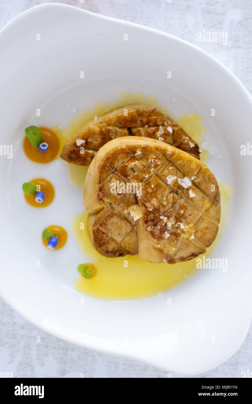 Fried Goose Liver with Apple Sauce on White Plate. Foie Gras Fine Food