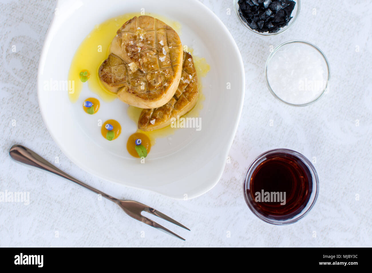 Fried Goose Liver with Apple Sauce on White Plate. Foie Gras Fine Food