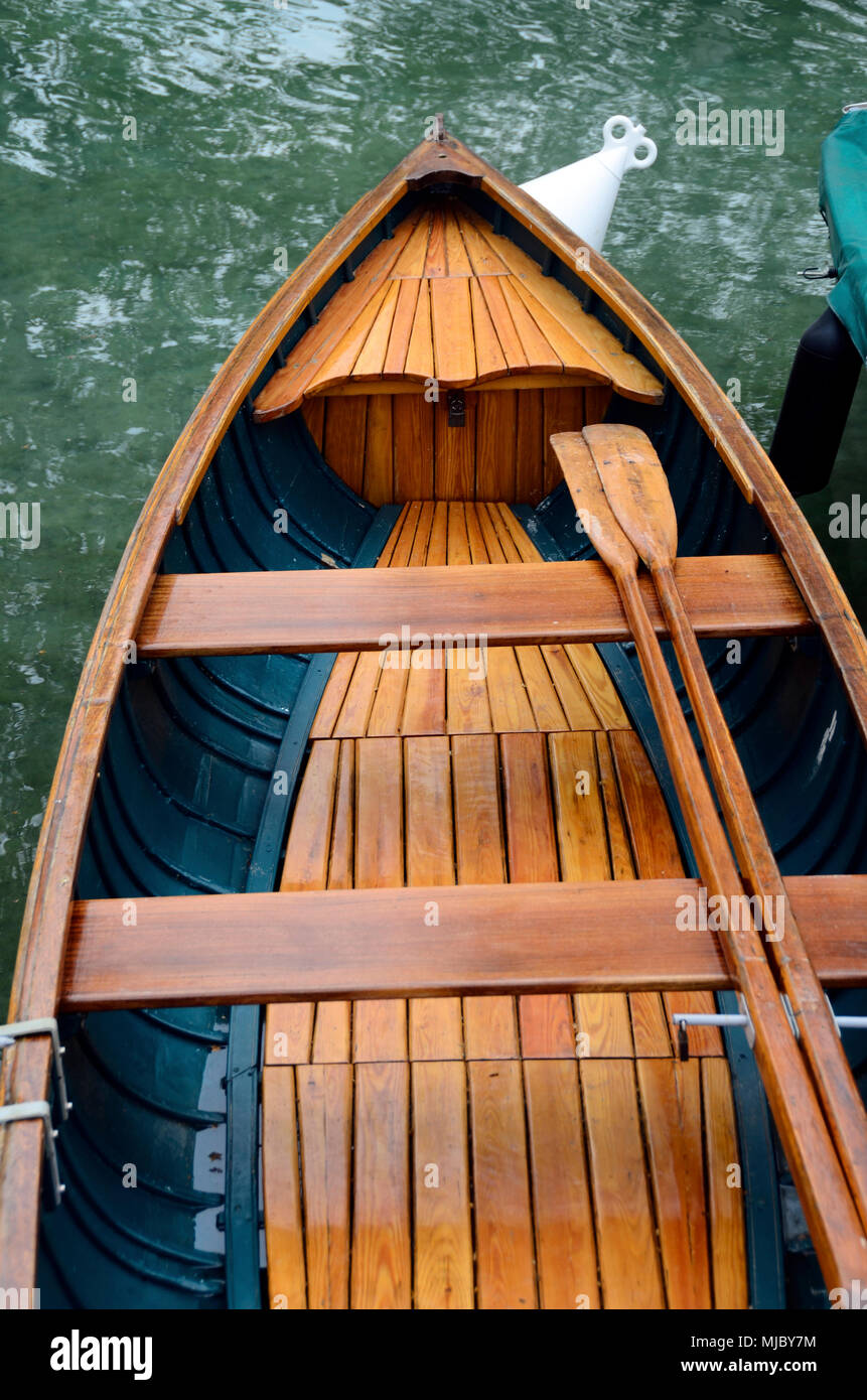 Close up of Wooden vintage small fishing boat and paddles Stock Photo -  Alamy
