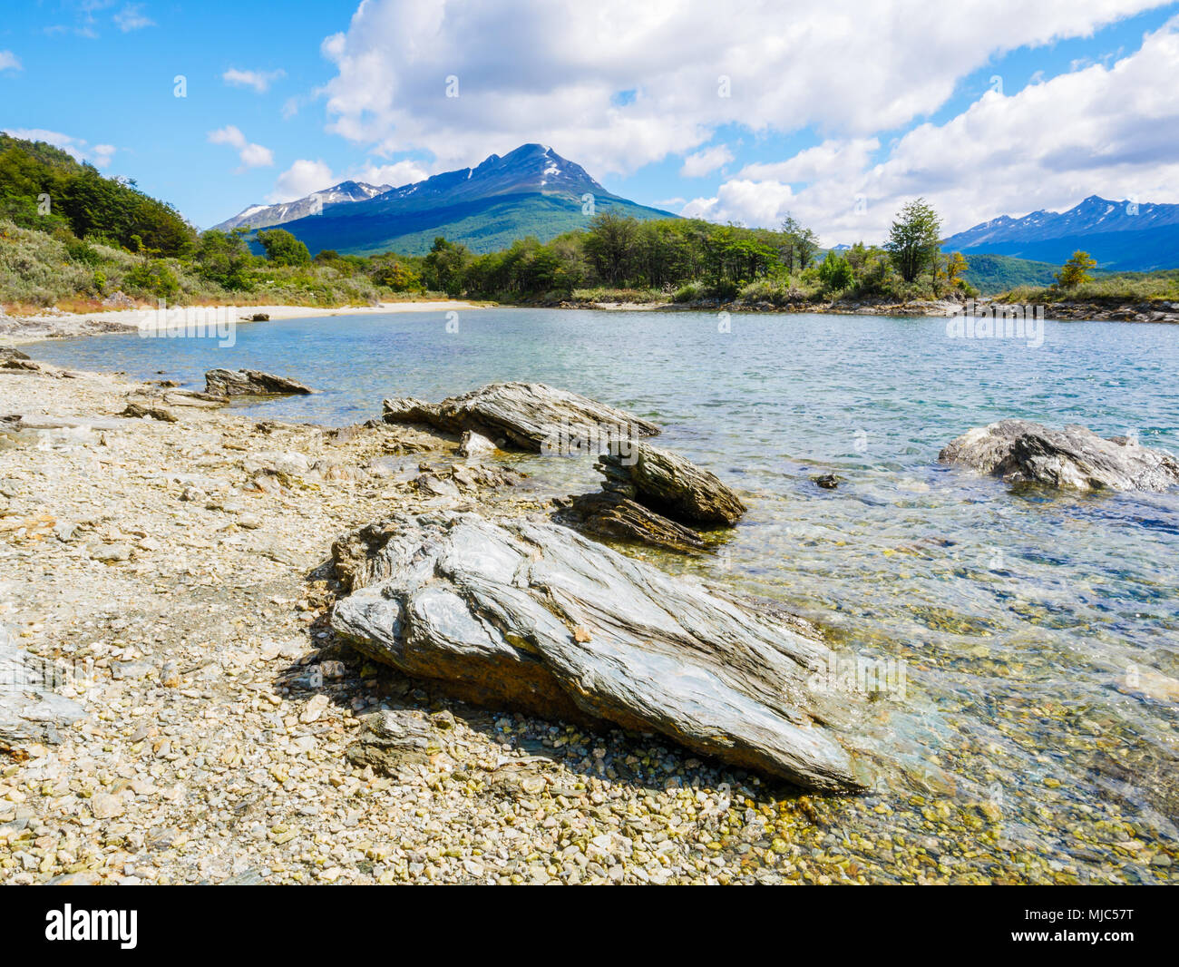 Stones on beach of Lapataia Bay with mountains in background, Terra del Fuego National Park near Ushuaia, Patagonia, Argentina Stock Photo