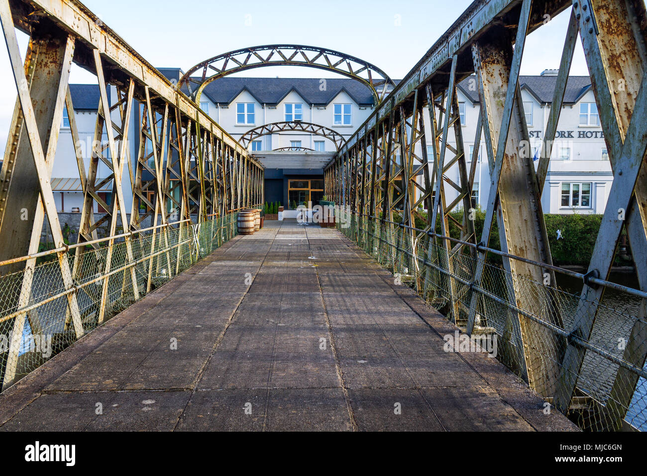 metal railway bridge now being used as an approach and outdoor eating and drinks area for a large hotel in skibbereen, ireland. Stock Photo