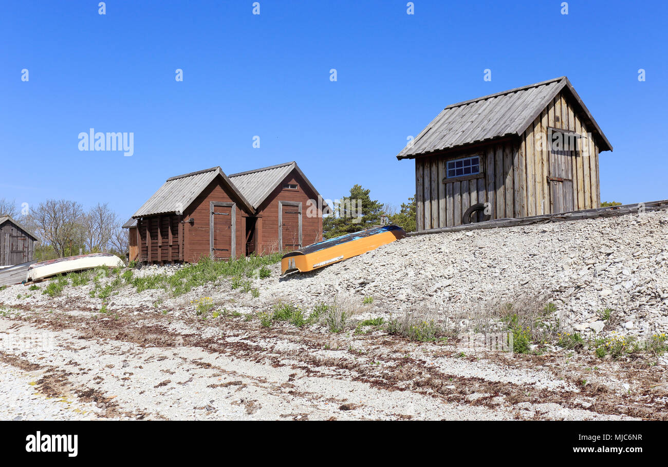 Fishing sheds and small boats at the beach in Blase, at the Swedish island Gotland. Stock Photo