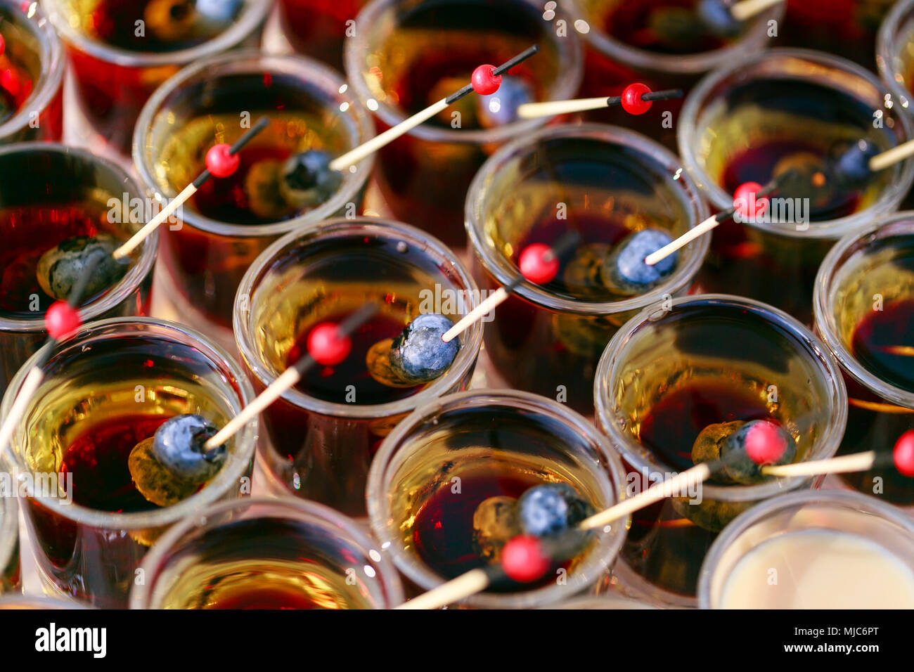 many ready alcoholic beverage. Shot cocktails stack with berry
