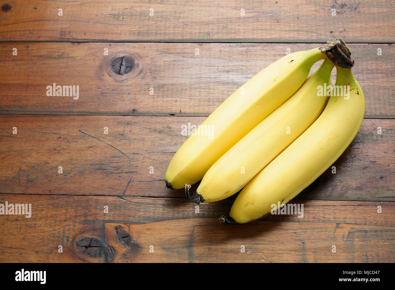 Banana on Wooden Background Stock Photo