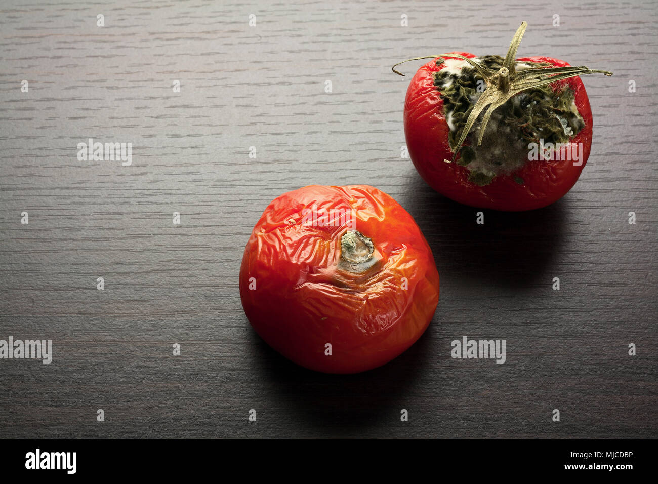 Rotten Tomato on Wooden Background Stock Photo
