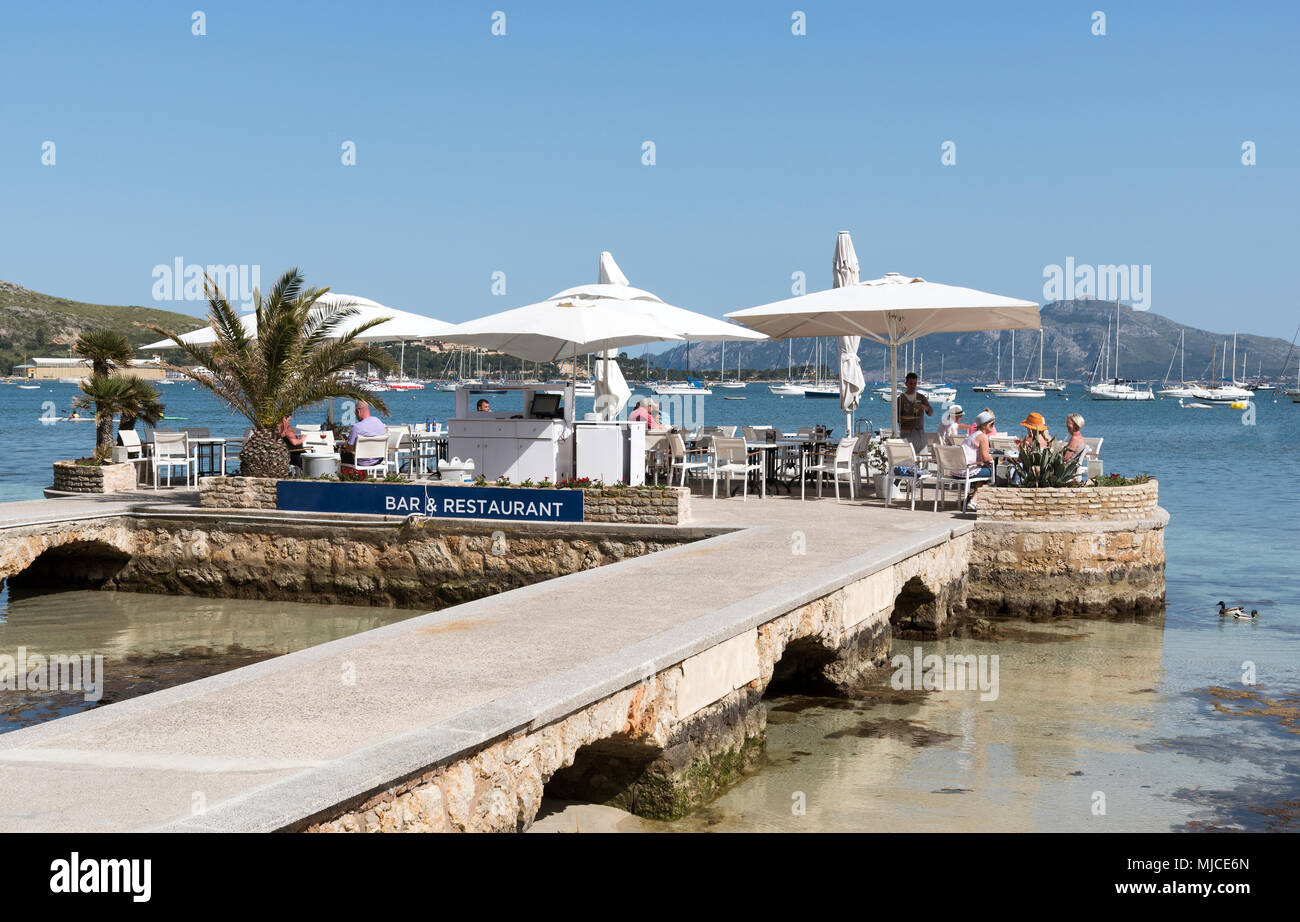 Port de Pollenca, Mallorca, Spain. 2018. Tourists at a waterfront bar ...