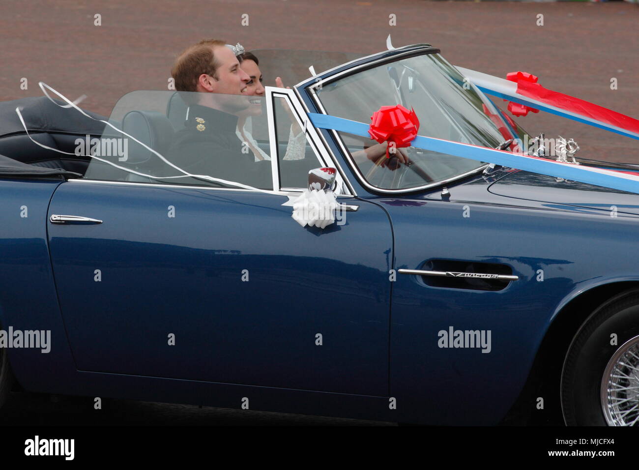 UK - Royal Wedding of Prince William and Kate (Catherine) Middleton - newlyweds William and Kate driving in an open top vintage Aston Martin Volante car along the Mall from  Buckingham Palace 29th April 2011 London UK Stock Photo
