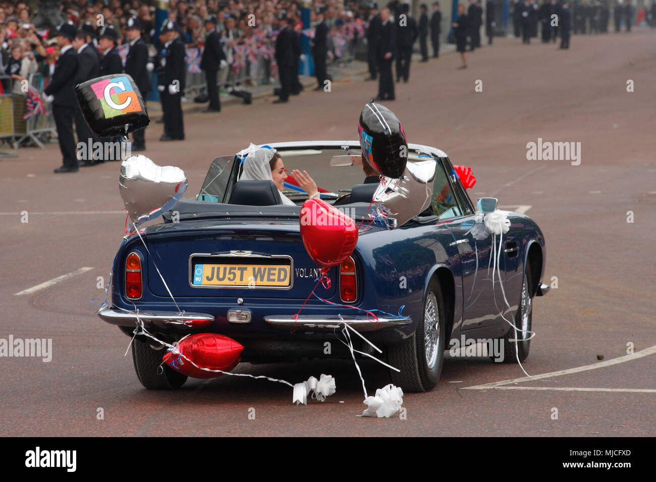 UK - Royal Wedding of Prince William and Kate (Catherine) Middleton - newlyweds William and Kate driving in an open top vintage Aston Martin Volante car along the Mall from  Buckingham Palace 29th April 2011 London UK Stock Photo