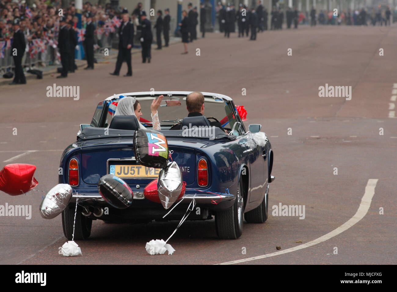 UK - Royal Wedding of Prince William and Kate (Catherine) Middleton - newlyweds William and Kate driving in an open top vintage Aston Martin Volante car along the Mall from  Buckingham Palace 29th April 2011 London UK Stock Photo