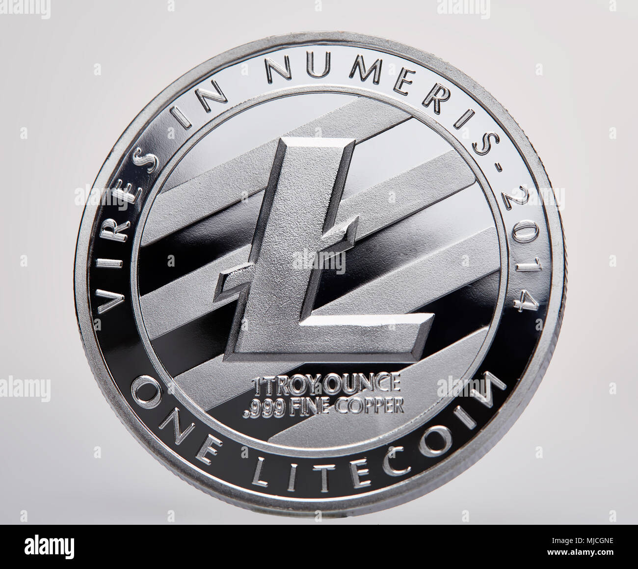Silver coin of digital crypto currency with the symbol of Litecoin and  motto on a white background, close-up, macro. Shiny cryptocoin. Conceptual  stud Stock Photo - Alamy