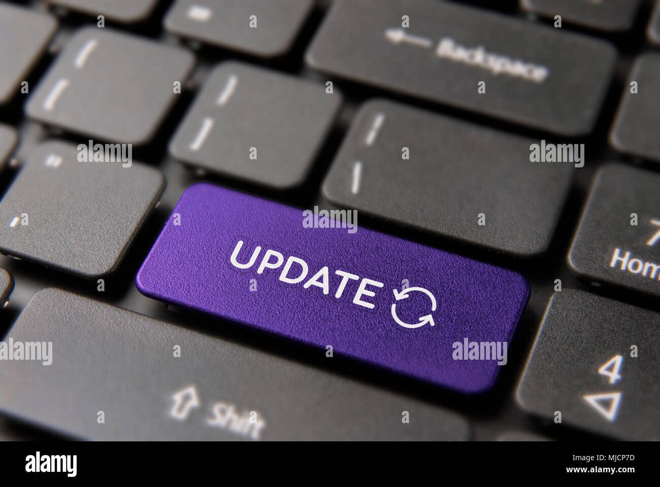 Online system update concept: color key button with updating process symbol on computer keyboard. Stock Photo