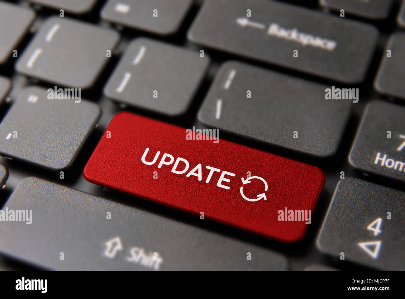 Online update computer keyboard button for internet maintenance concept. Updating process keypad key in red color. Stock Photo