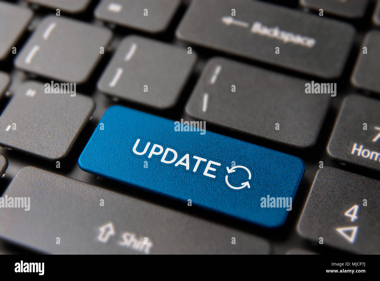 Online update computer keyboard button for internet software concept. Updating process keypad key in blue color. Stock Photo