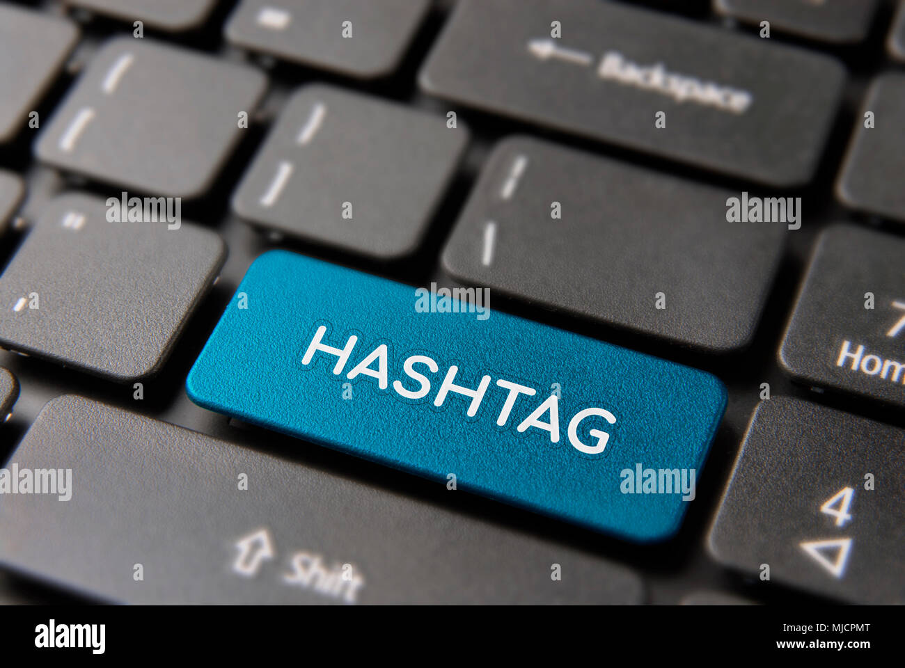 Social media hashtag button on computer keyboard for new popular trend concept. Hash tag text key in blue color. Stock Photo