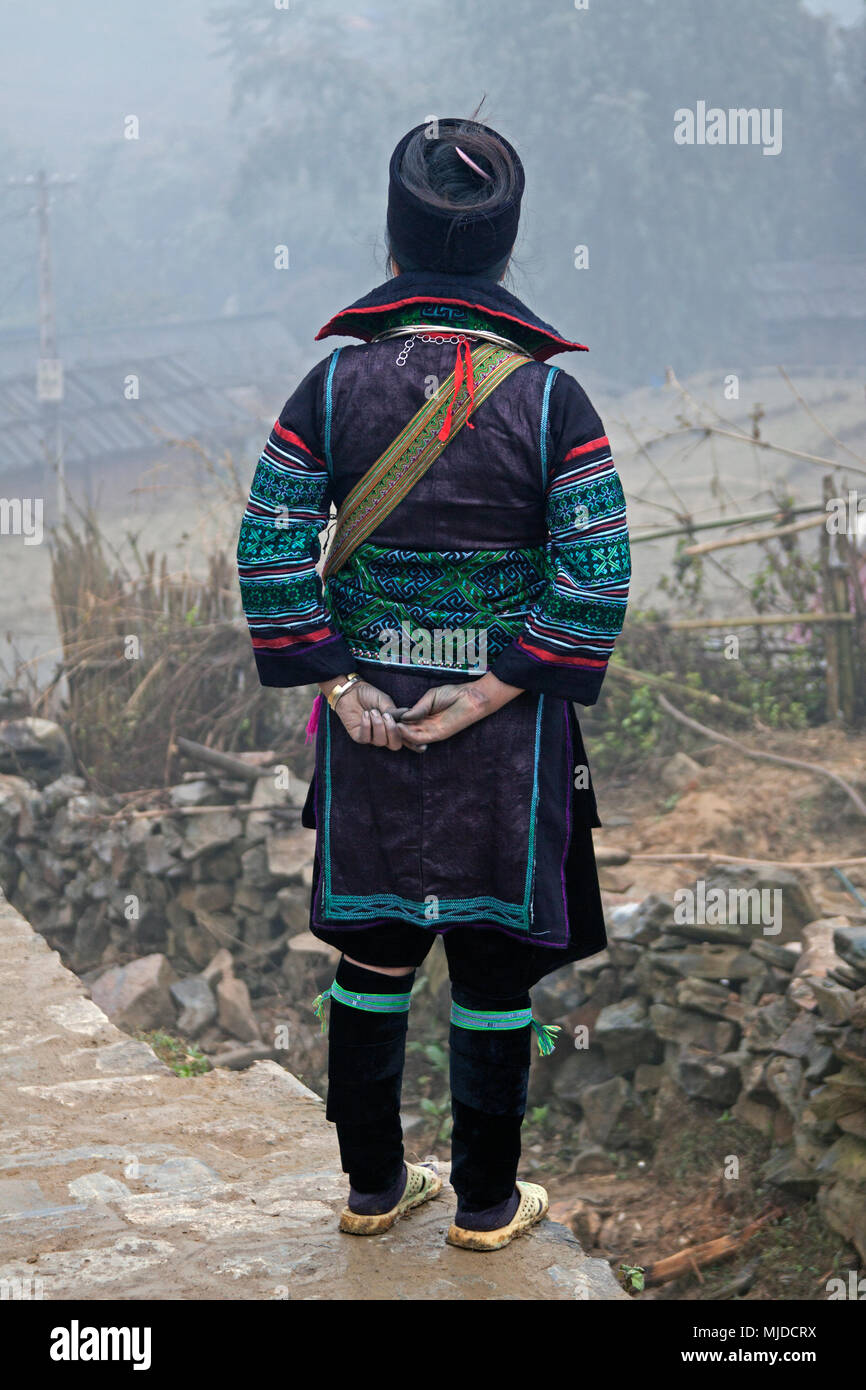 Black Hmong man in full traditional dress over looking valley at Can Cau market in Vietnam. Stock Photo
