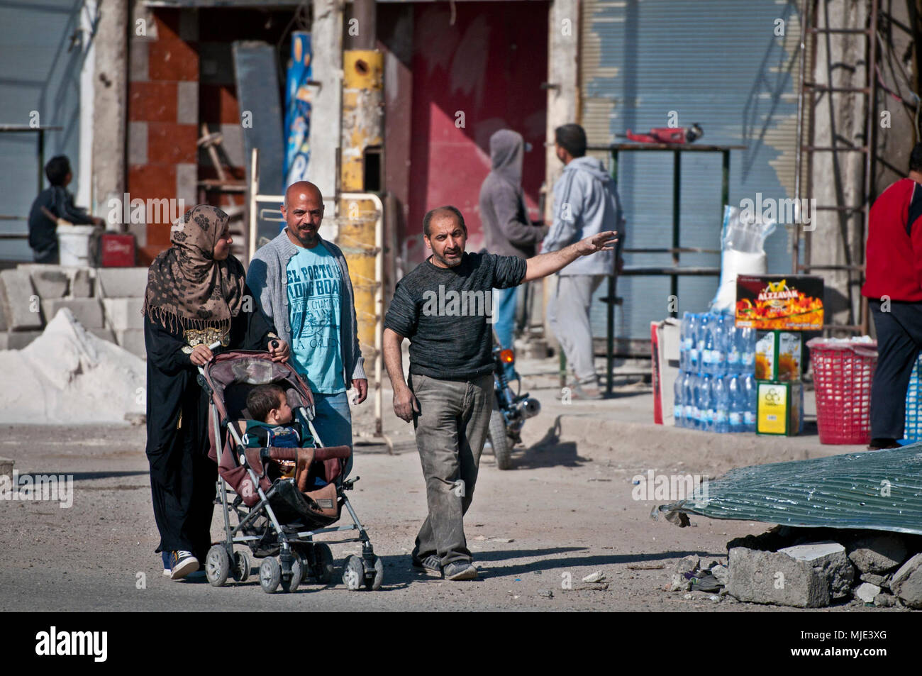 A Syrian family examines the reconstruction efforts and reopened markets near the Naim traffic circle, Raqqah, Syria, March 13, 2018. The return of vendors and markets are just one of the several signs that life is beginning to return to normal after the Syrian Democratic Forces, under the advisement of the Global Coalition to Defeat the Islamic State of Iraq and Syria, militarily defeated ISIS in the city. (U.S. Army Stock Photo