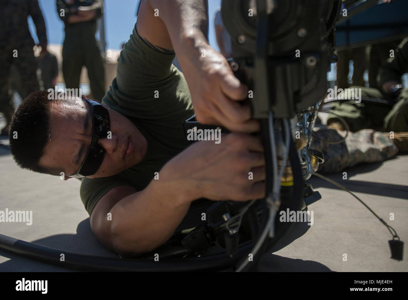 U.S. Marine Corps Staff Sgt. David Lieu, a Marine Aviation Logistics Squadron 14 aviation ordnance technician, assembles an A/E32K-11 munitions lifting assembly during training in support of Weapons and Tactics Instructor course 2-18 at Marine Corps Air Station Yuma, Ariz., March 14. WTI is a seven-week training event hosted by Marine Aviation Weapons and Tactics Squadron 1 cadre, which emphasizes operational integration of the six functions of Marine Corps aviation in support of a Marine Air Ground Task Force and provides standardized advanced tactical training and certification of unit instr Stock Photo