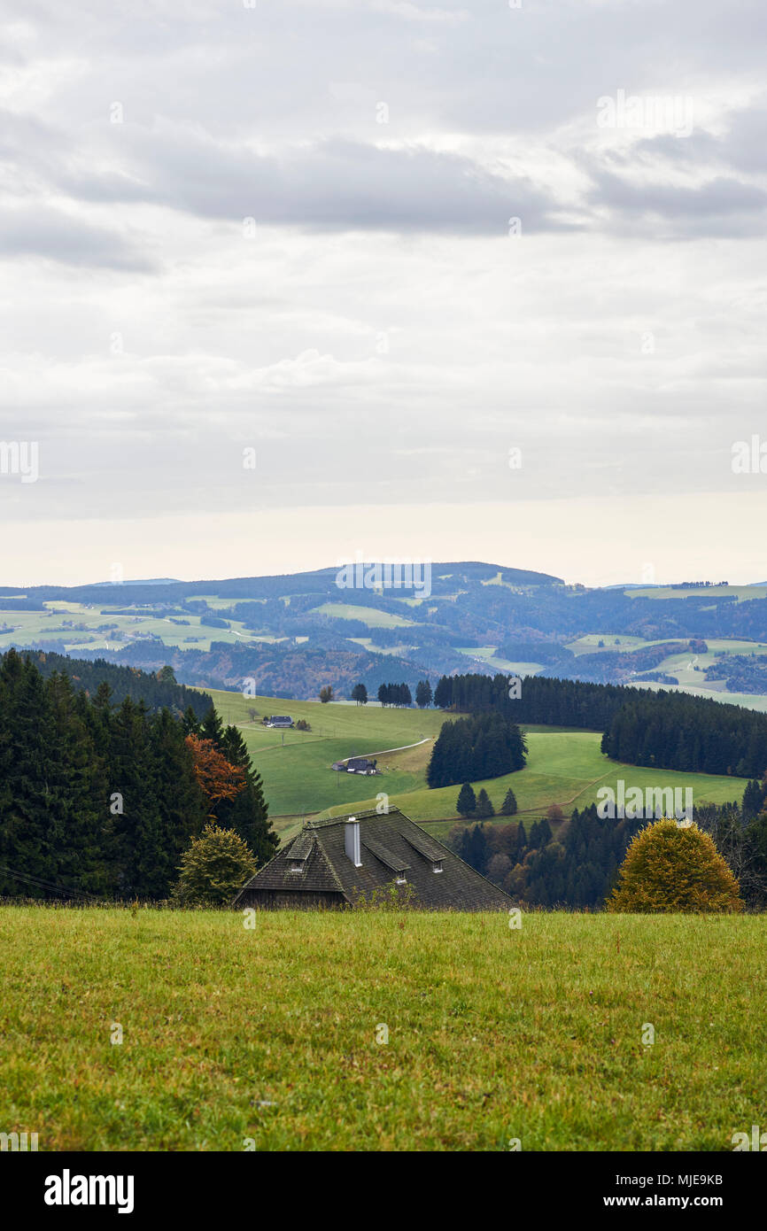 view to hills, forests, farms and pastures, sky with clouds Stock Photo