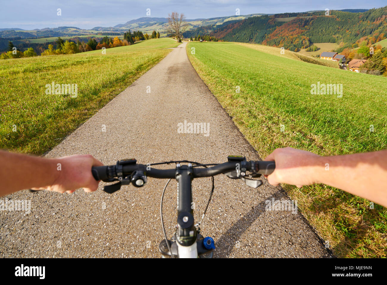 Hands on a handlebar of a bicycle with panoramic, Black Forest, bird's-eye view Stock Photo