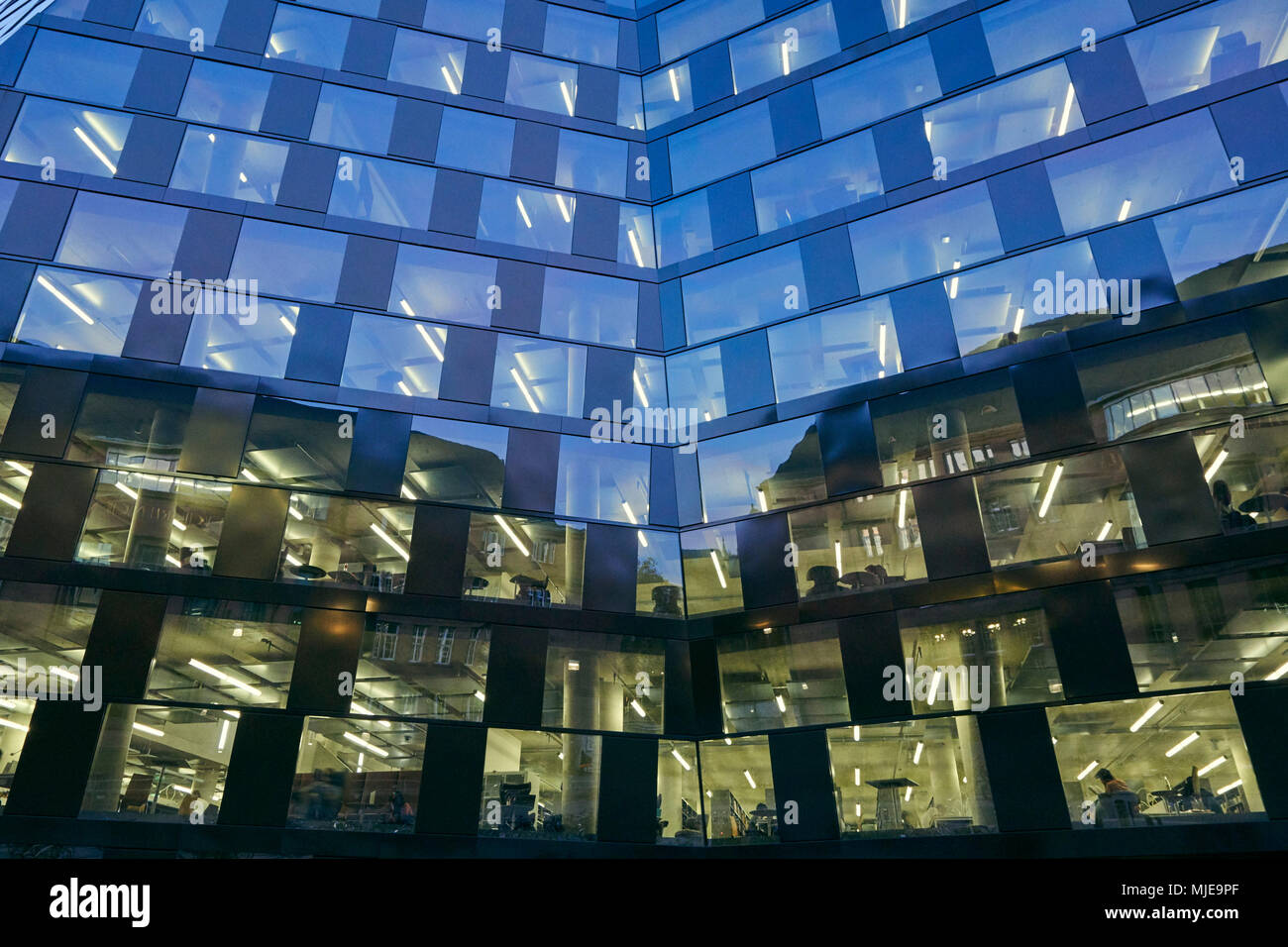 modern building, facade, glass, metal, windows, lighted, sky, dusk Stock Photo