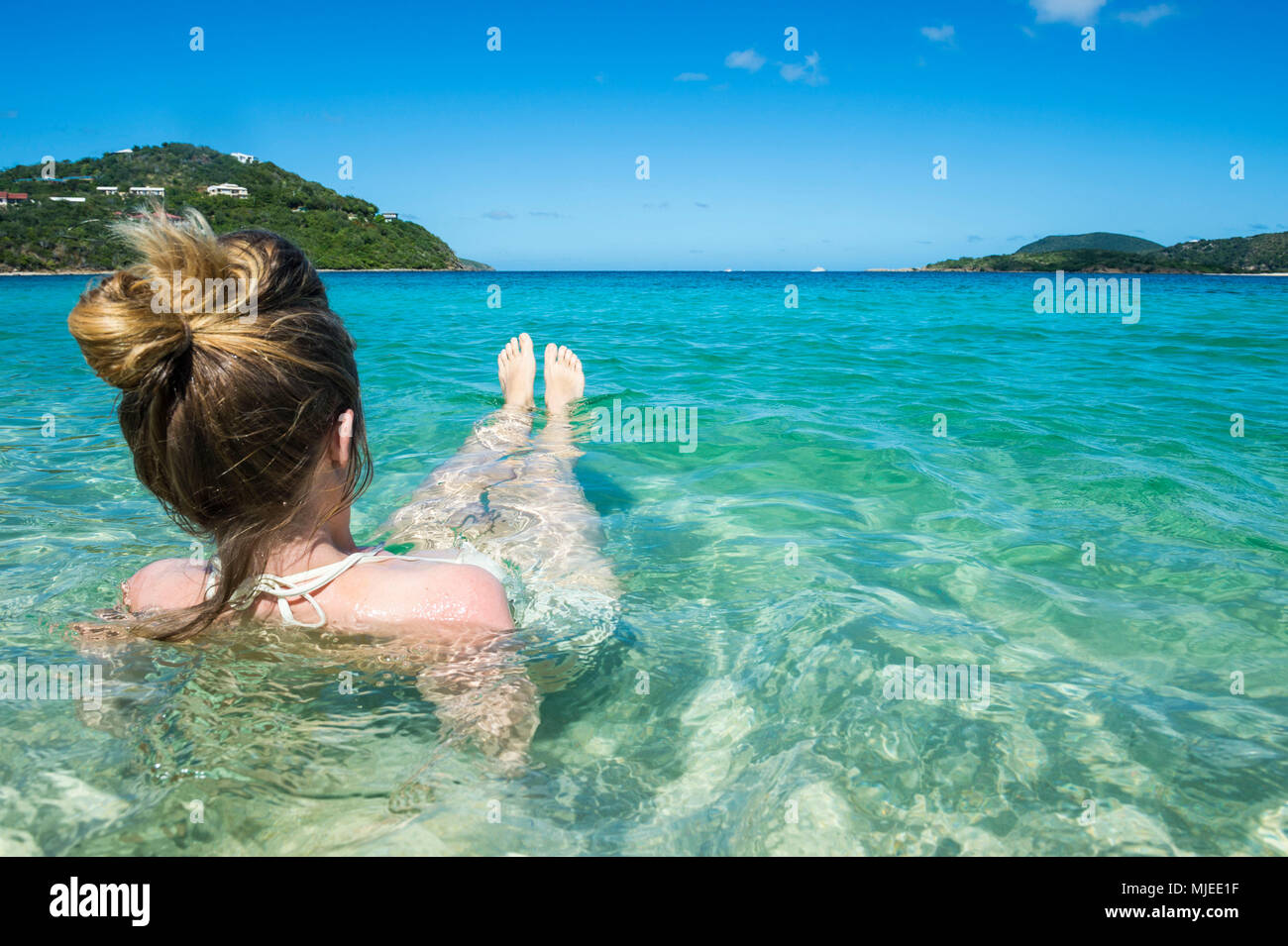 Woman relaxing on long bay beach, Beef island, Tortola, British Virgin Islands Stock Photo