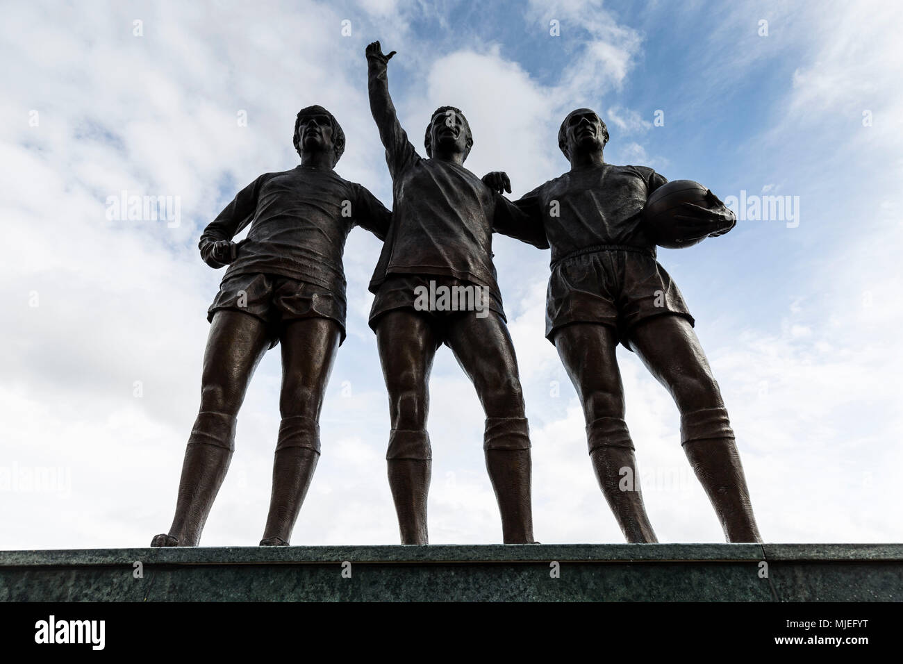 Europe, England, United Kingdom, Manchester, Old Trafford football stadium, United Trinity Statue, George Best, Denis Law, Sir Bobby Charlton Stock Photo