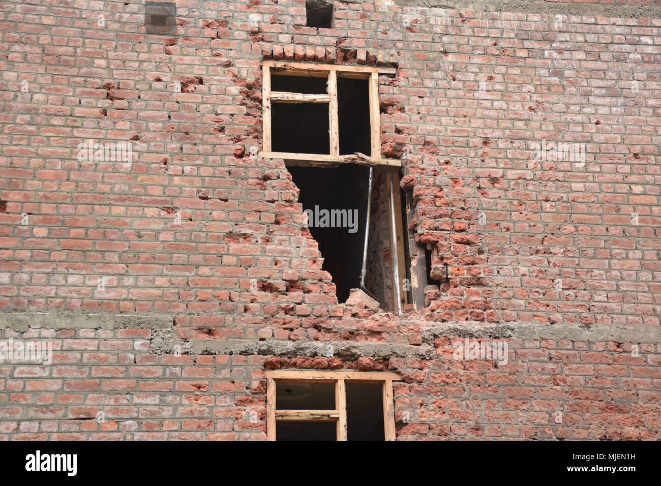 Damaged parts of Residencial building which were gutted during Encounter in Srinagar. 4 Killed and several injured in an encounter between Indian forces and militants at chatabal area of Srinagar summer capital of Indian Kashmir on Saturday. Three militants were killed during a brief shootout after government forces laid seige around densely populated chatabal area of Srinagar. A young man also died after he was hit by the armoured vehicle during the clashes between the residents and police force as residents tried to help the Militants in escape. Stock Photo