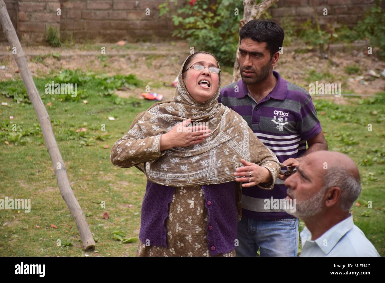 May 5, 2018 - Srinagar, Jammu & Kashmir, India - Women mourns near the Encounter site in Srinagar.4 Killed and several injured in an encounter between Indian forces and militants at chatabal area of Srinagar summer capital of Indian Kashmir on Saturday. Three militants were killed during a brief shootout after government forces laid seige around densely populated chatabal area of Srinagar. A young man also died after he was hit by the armoured vehicle during the clashes between the residents and police force as residents tried to help the Militants in escape. (Credit Image: © Abbas Idrees/SOP Stock Photo