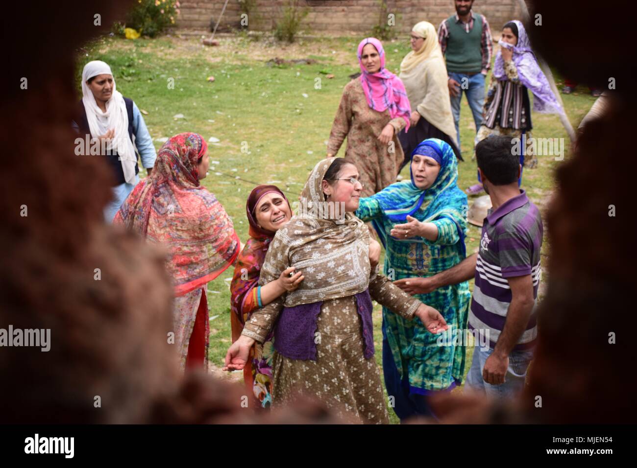 May 5, 2018 - Srinagar, Jammu & Kashmir, India - Women mourns near the Encounter site in Srinagar.4 Killed and several injured in an encounter between Indian forces and militants at chatabal area of Srinagar summer capital of Indian Kashmir on Saturday. Three militants were killed during a brief shootout after government forces laid seige around densely populated chatabal area of Srinagar. A young man also died after he was hit by the armoured vehicle during the clashes between the residents and police force as residents tried to help the Militants in escape. (Credit Image: © Abbas Idrees/SOP Stock Photo